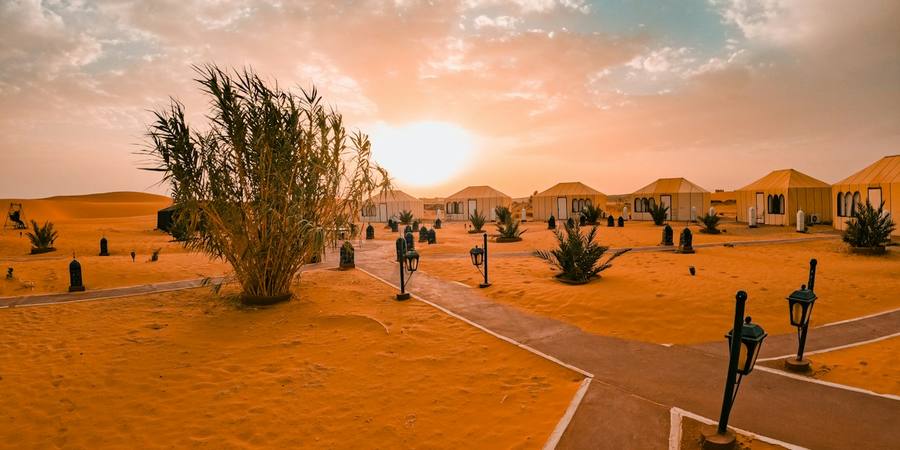 Desert camp tents at sunset in Merzouga